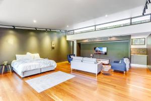 a bedroom with a bed and a living room at Calanthe Acreage - Doonan in Doonan +16 photos