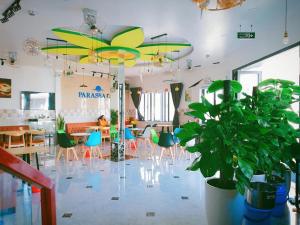 a dining room with chairs and a table with a plant at Phan Rang Hotel in Phan Rang–Tháp Chàm