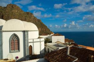 a view of a church and the ocean at Casa Rural Los Helechos in Agulo