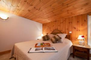 a bedroom with a bed with a book on it at Résidence Le Cristal - Lognan 7 - Happy Rentals in Chamonix