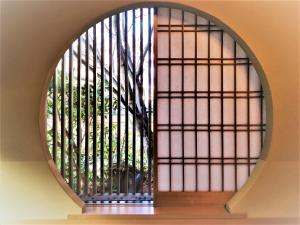 a window in a building with a tree through it at Hotel Kazahaya in Hita