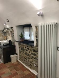 a bathroom with a radiator in a room at Le Ciappe Castelbianco Terra CITR 9020-BEB-0003 in Castelbianco