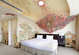 a bedroom with a bed with a painting on the wall at Park Hotel Tokyo in Tokyo