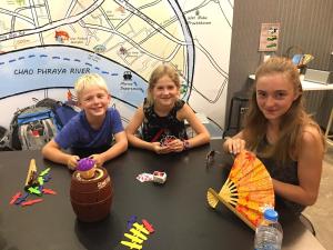 two girls and a boy sitting at a table at Norn Yaowarat Hotel in Bangkok