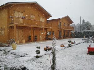 a house with snow on the ground in front of it at Kastor Chalets in Ampelokipoi