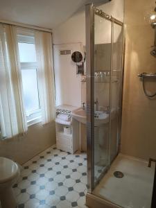 a bathroom with a shower and a sink at East Mount House in Barrow in Furness