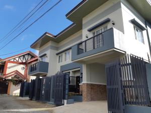 a house with a fence in front of it at Restful 3BR Hillside Duplex House in Baguio
