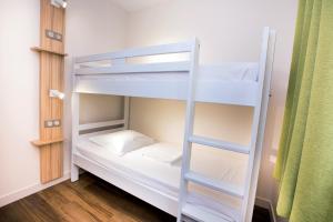 a couple of bunk beds in a room at Hôtel Vacances Bleues Delcloy in Saint-Jean-Cap-Ferrat
