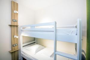 a bunk bed room with two bunk beds at Hôtel Vacances Bleues Delcloy in Saint-Jean-Cap-Ferrat