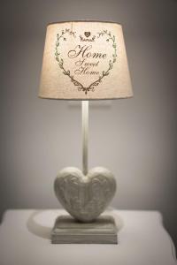 a heart shaped lamp sitting on top of a table at Luxury Laura Vatican Apartment ROMA CENTRO in Rome