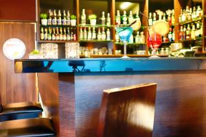 a bar with a counter with glasses on it at Focus Hotel Gdańsk in Gdańsk