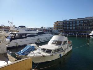 two boats are docked at a dock in the water at Apart-rent Apartment Port Salins 0155 in Empuriabrava