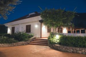 a white house with stairs leading to it at night at Il Giardino di Venere in Mondello