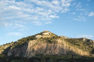 a mountain with two houses on top of it at Il Giardino di Venere in Mondello