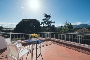 a patio with two chairs and a table on a balcony at Il Giardino di Venere in Mondello