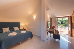 a bedroom with a bed and a table and a window at Il Giardino di Venere in Mondello