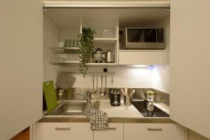 a kitchen with a sink and a microwave at San Frediano 56 in Florence