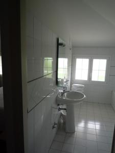 a white bathroom with a sink and a mirror at Casa F.A.C.I in Marina di Massa +43 photos