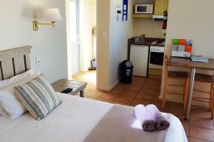 um quarto com uma cama com toalhas em On the Beach 2 em Langebaan