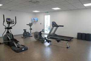 a gym with several exercise bikes in a room at Hôtel Nakara by Odalys in Cap d'Agde +72 photos