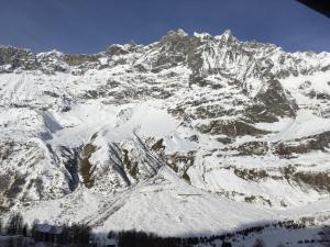 a mountain covered in snow with a blue sky at Cielo Alto I Dadi in Breuil-Cervinia