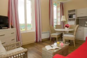 a living room with a couch and a table at Résidence de Tourisme Vacances Bleues Villa Regina in Arcachon