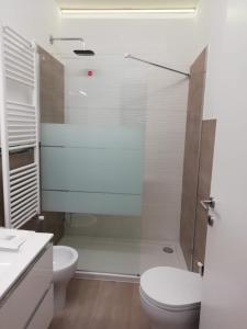 a bathroom with a toilet and a glass shower at Indipendent Luxury Mini Apartment in Pescara