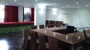 a conference room with a large table and chairs at Hotel de la Poste in Antsiranana