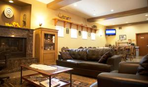 a living room with a couch and a fireplace at FairBridge Inn & Suites in Leavenworth