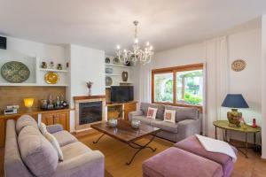 a living room with a couch and a table at New! Villa Can Colomaret Carmen in Santa Eularia des Riu