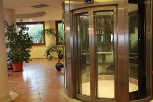 a lobby with a revolving door in a building at Hotel Santa Chiara in Capo Vaticano