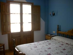 A bed or beds in a room at Posada Sobrevilla