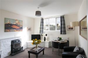 a living room with a couch and a fire place at Quiet, Convenient, Hawick Flat in Hawick