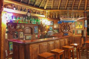 a bar with a bunch of bottles on the wall at Pousada Colibri in Morro de São Paulo