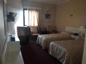 Beirut Hotel Cairo tesisinde bir odada yatak veya yataklar