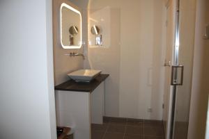 a bathroom with a sink and a mirror at At number 6 in Amsterdam