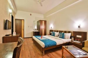 a hotel room with a bed and a table and a couch at Hotel President Inn By Sky Stays in Gandhinagar