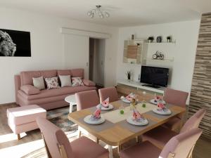 sala de estar con mesa y sillas rosas en Lion Apartment Zagreb en Zagreb