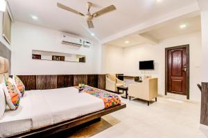 a bedroom with a bed and a desk at Capital Suites in Bangalore