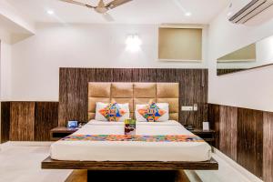 a bedroom with a large bed in a room at Capital Residency in Bangalore