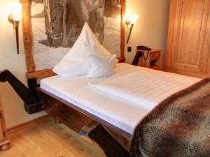 a bed in a room with a painting on the wall at Naturresort Tannenhof GmbH in Großmaischeid