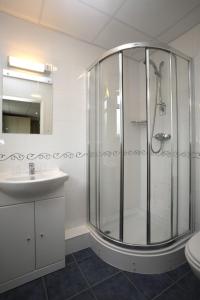 a bathroom with a shower, sink, and toilet at Westhill Country Hotel in Saint Helier Jersey