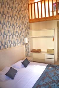 Postel nebo postele na pokoji v ubytování Ouril Hotel Julia