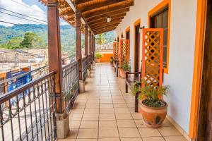 a balcony of a house with plants on it at Berakah B&B- Central Park in Copán Ruinas