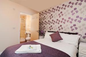 a bedroom with a bed with a tray on it at Central 2 bedroom apartment in Basingstoke