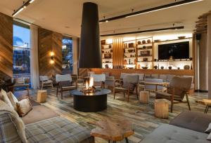 a lobby with couches and tables and a bar at Urban Lodge Hotel in Amsterdam