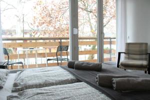 a bedroom with a bed and a large window at Sió Lodge in Siófok