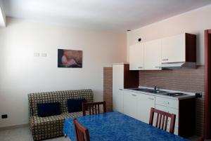 a kitchen and a dining room with a table at Residence Pax in Fiumaretta di Ameglia