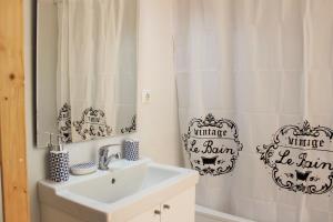 a bathroom with a sink and a shower curtain at Casa Rio da Saudade in Lisbon