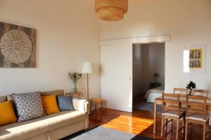 a living room with a couch and a table at Casa Rio da Saudade in Lisbon